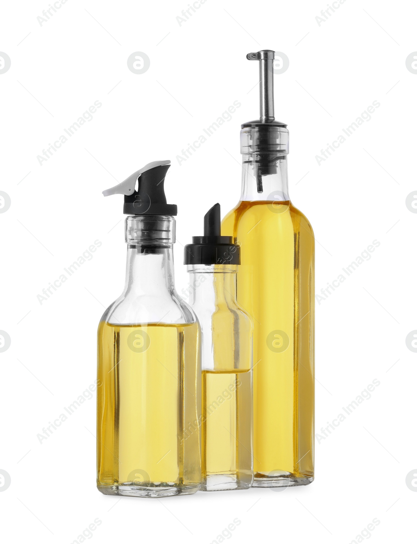 Photo of Different glass bottles of cooking oil on white background