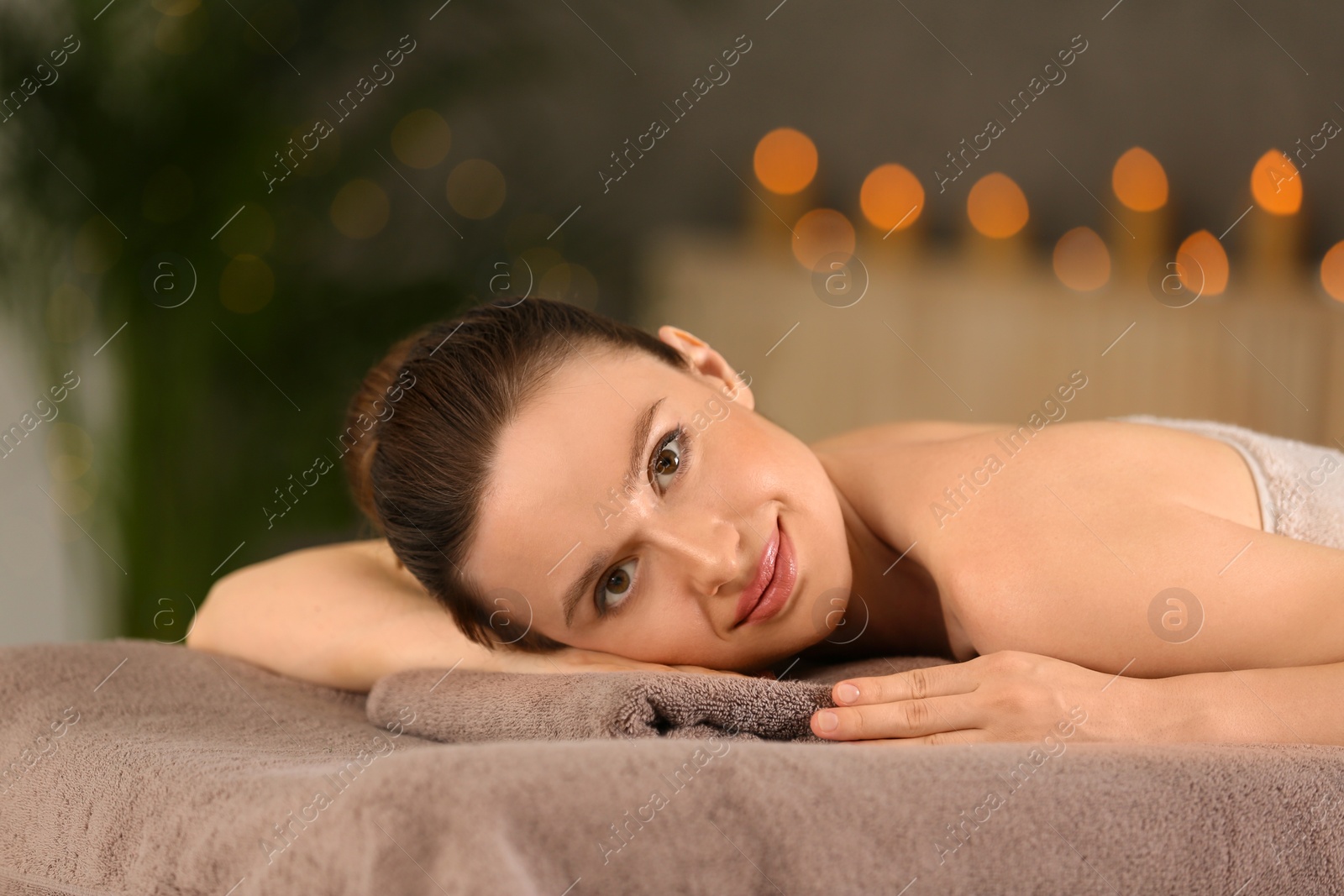 Photo of Beautiful young woman relaxing in spa salon