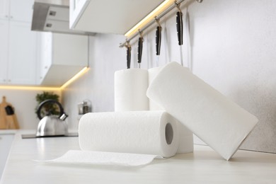 Rolls of paper towels on white countertop in kitchen