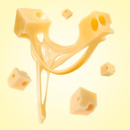 Pieces of cheese falling on yellow background