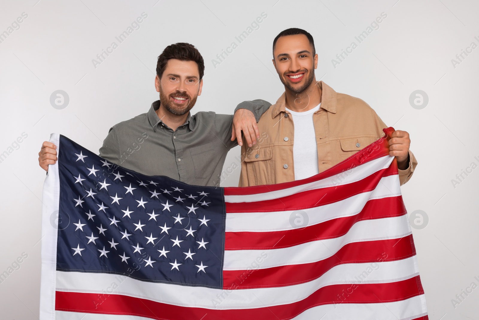 Photo of 4th of July - Independence Day of USA. Happy men with American flag on white background