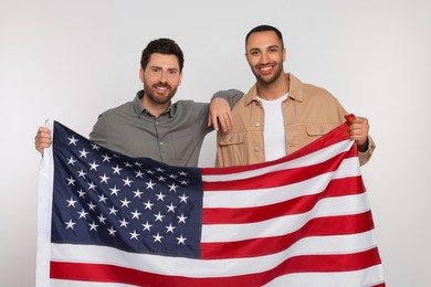 4th of July - Independence Day of USA. Happy men with American flag on white background
