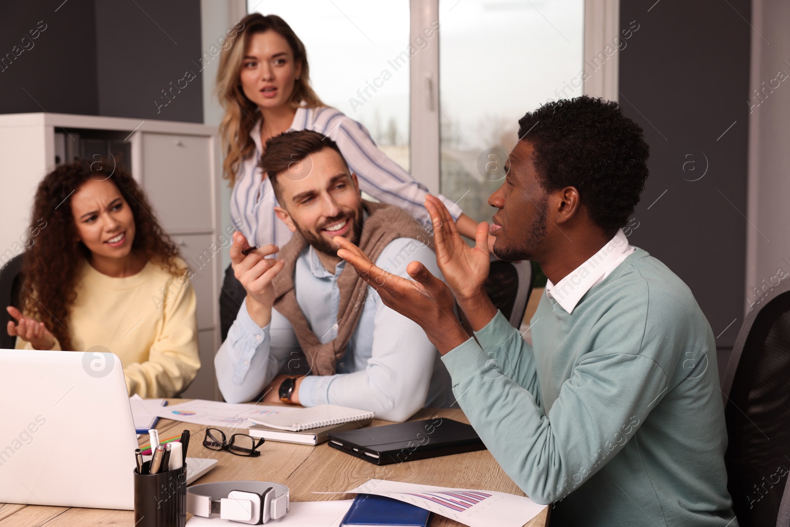 Photo of Team of employees working together in office. Startup project