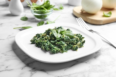 Tasty spinach on white marble table. Healthy food