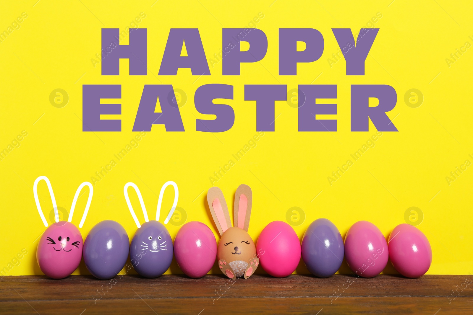 Image of Several eggs with ears as Easter bunnies among others on wooden table against yellow background