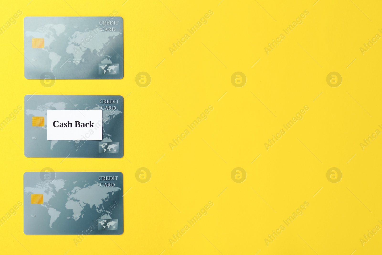 Photo of Many credit cards on yellow background, flat lay with space for text. Cashback concept