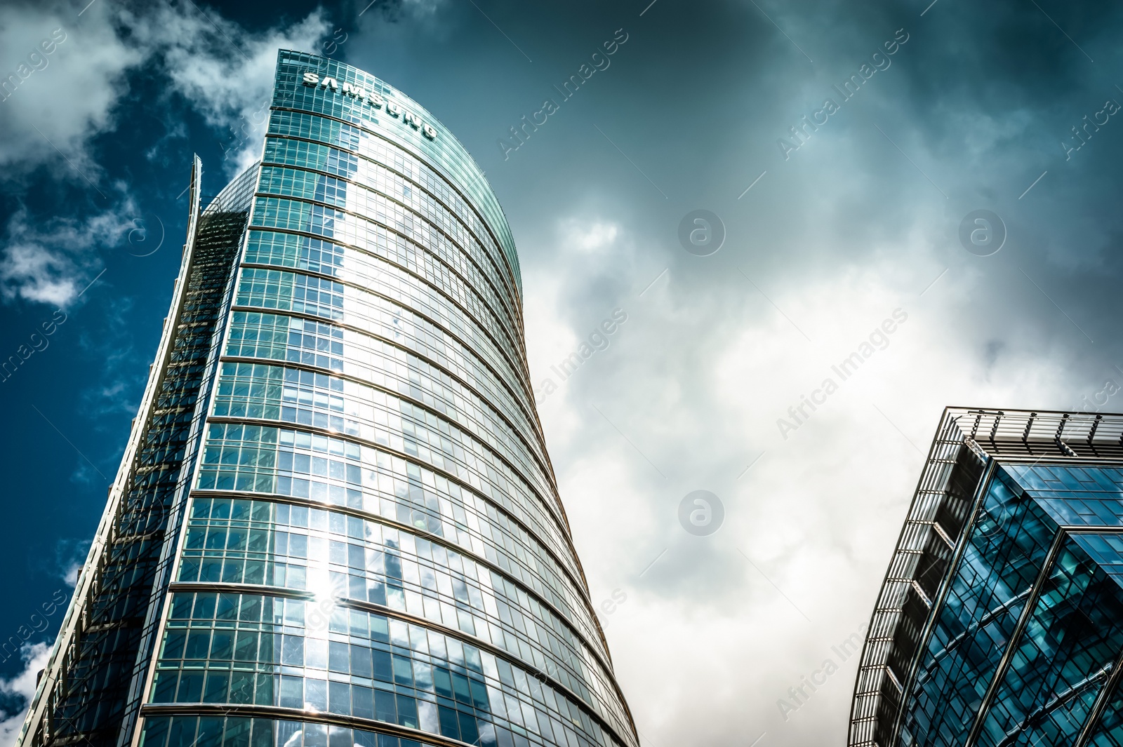 Photo of Warsaw, Poland - May 28, 2022: Beautiful Samsung building under cloudy sky, low angle view
