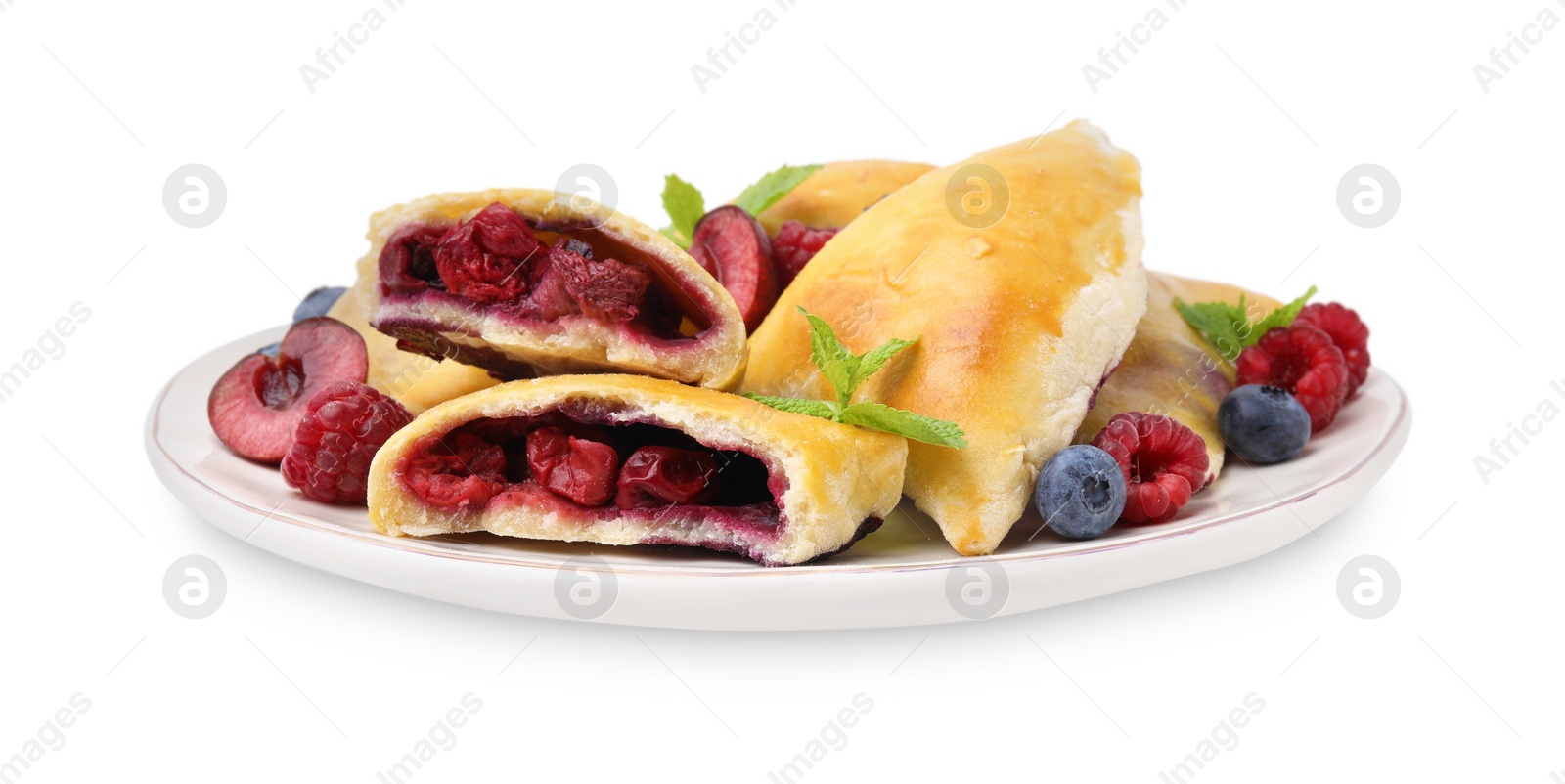 Photo of Plate of tasty samosas with berries and mint leaves isolated on white