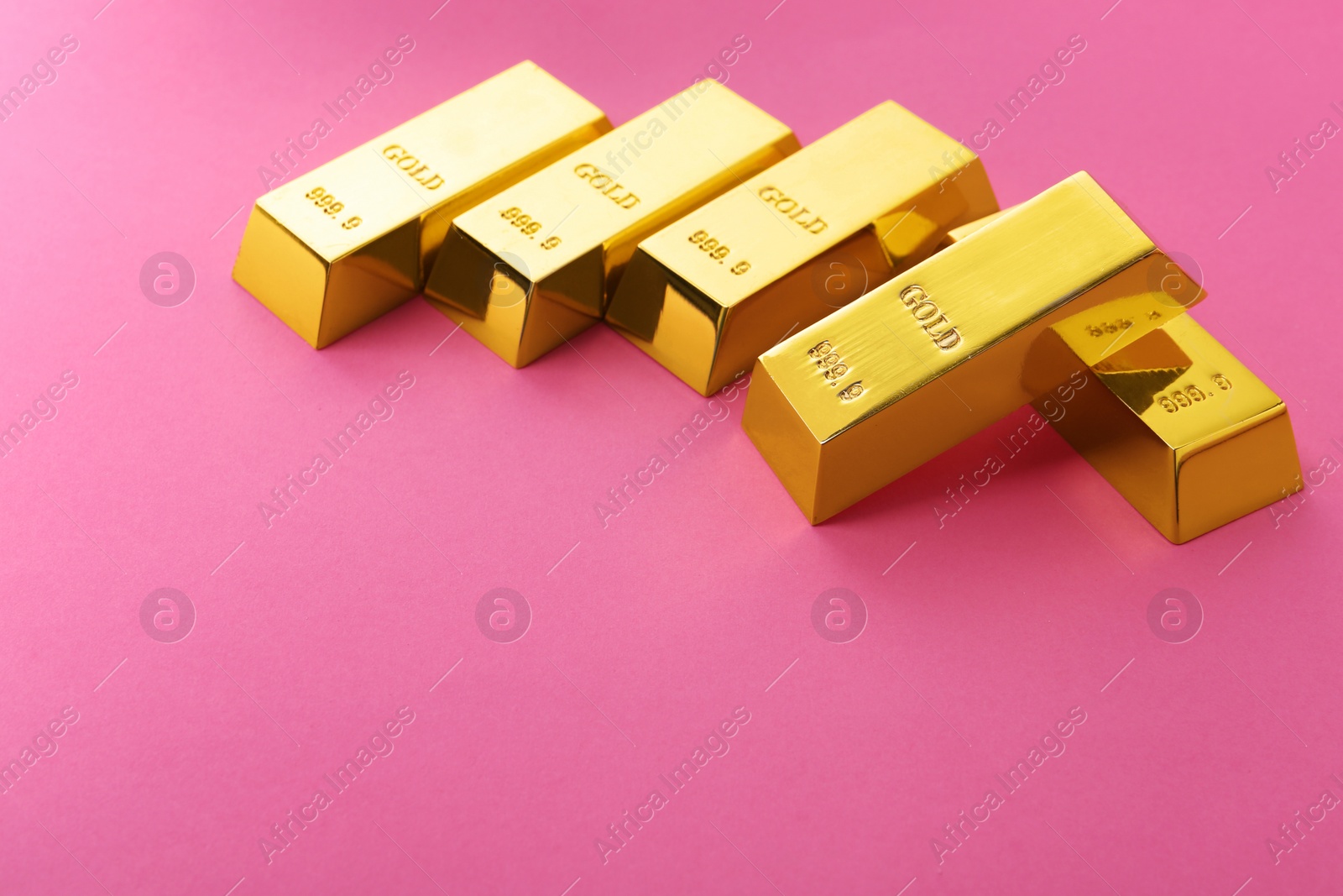 Photo of Precious shiny gold bars on color background. Space for text