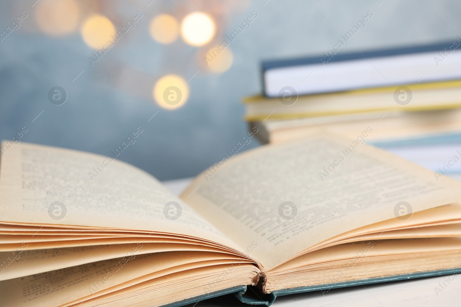 Photo of Open hardcover book on white table, closeup