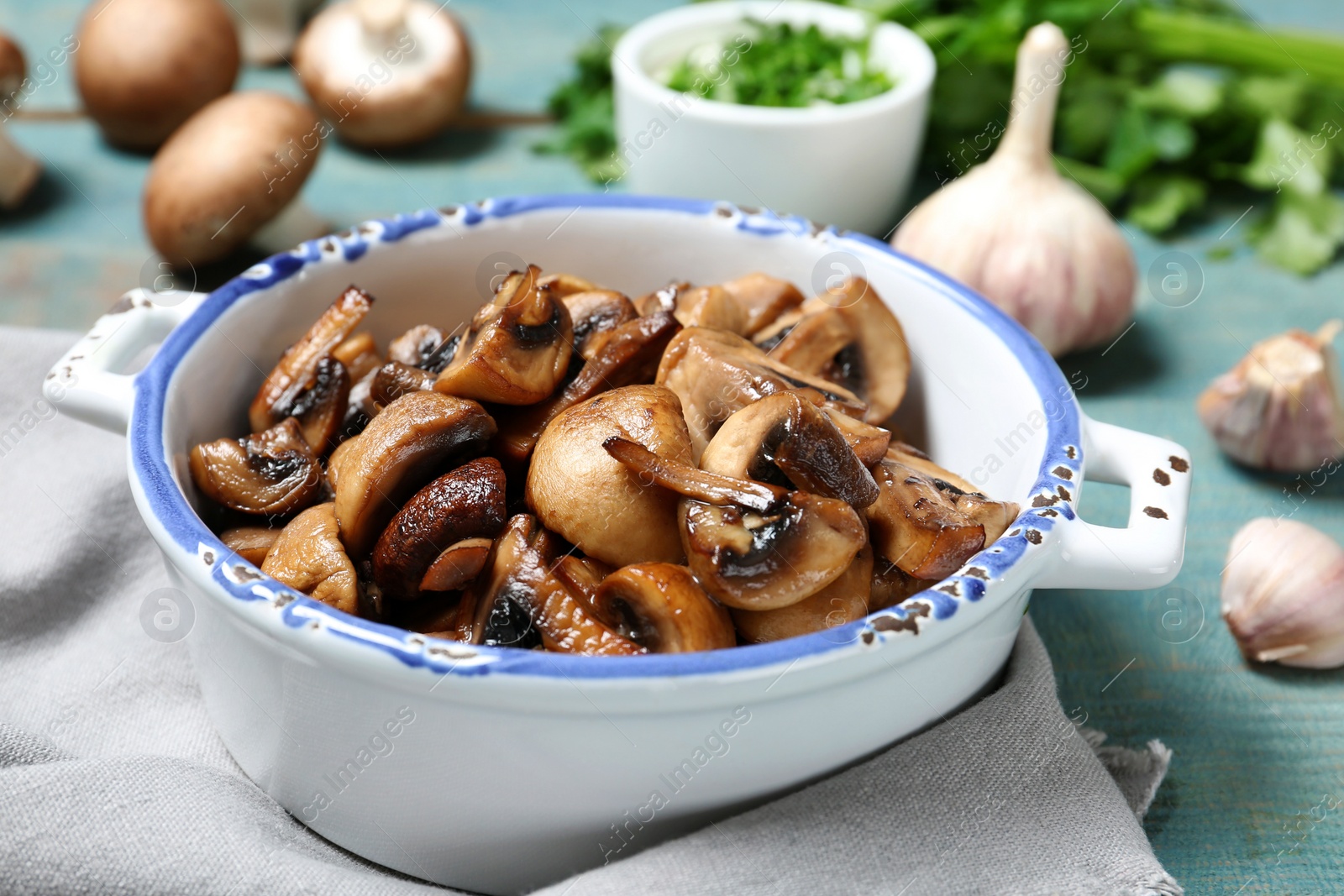 Photo of Dish of fried mushrooms on table, closeup