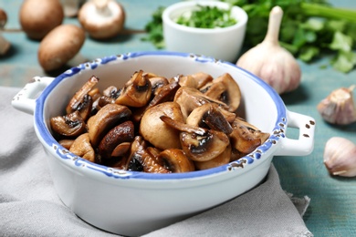 Dish of fried mushrooms on table, closeup