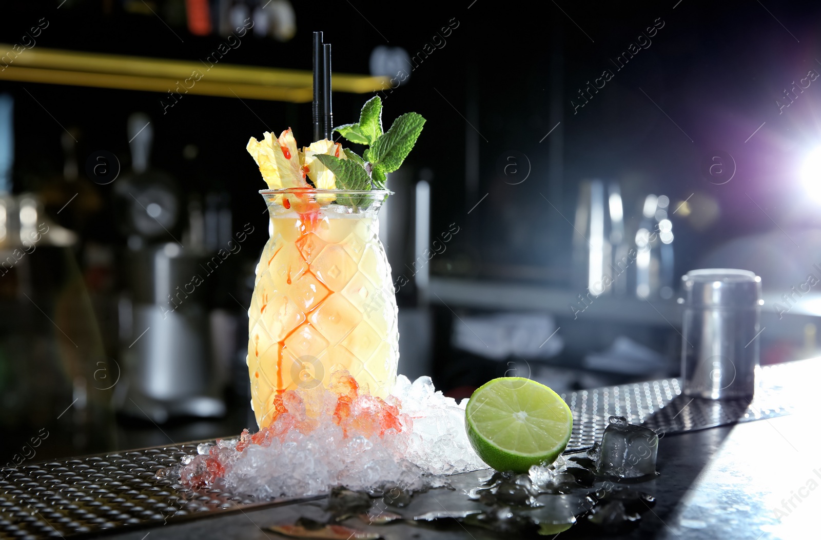 Photo of Fresh alcoholic Malibu and pineapple juice cocktail on bar counter. Space for text