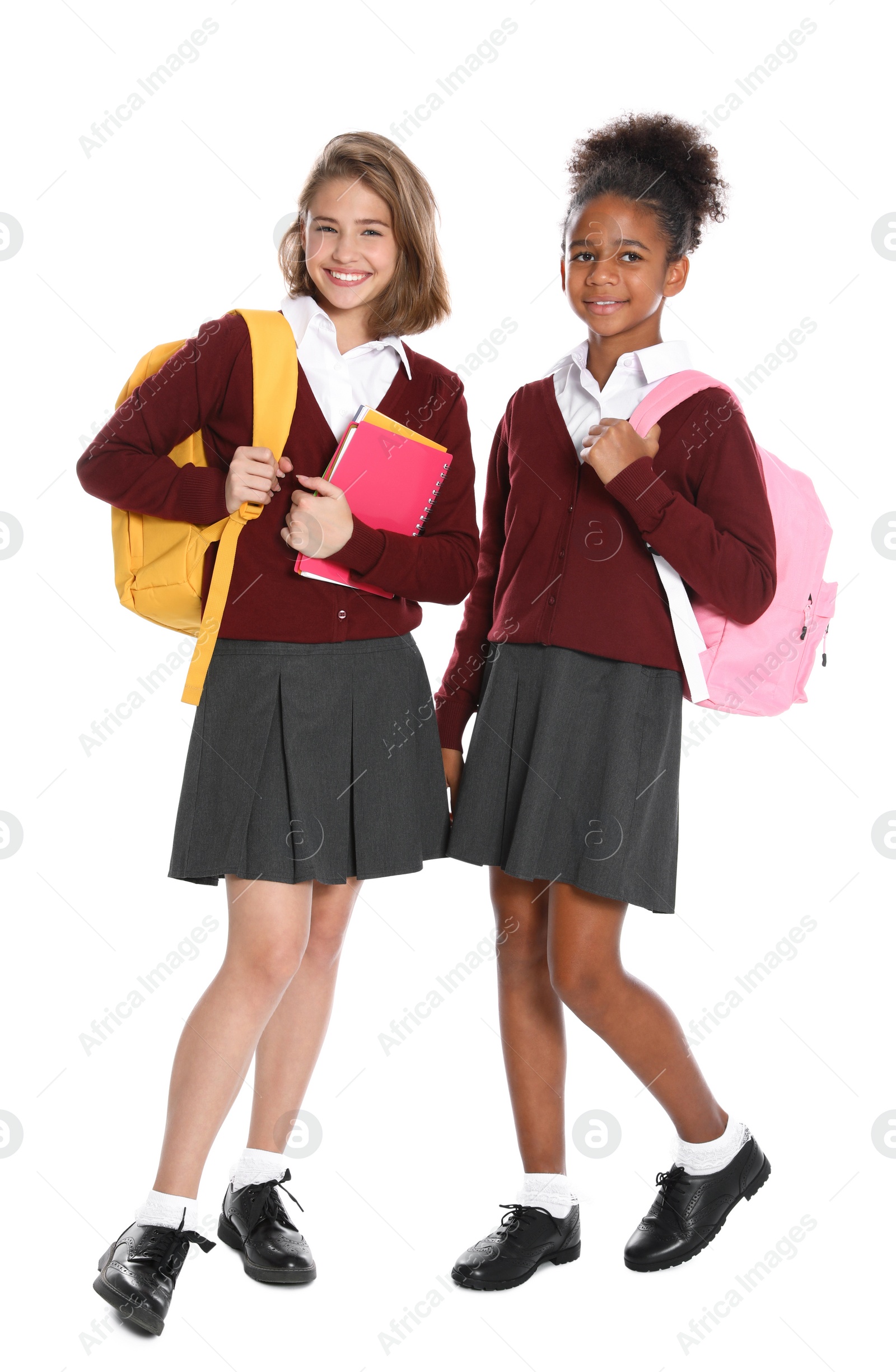 Photo of Happy girls in school uniform on white background