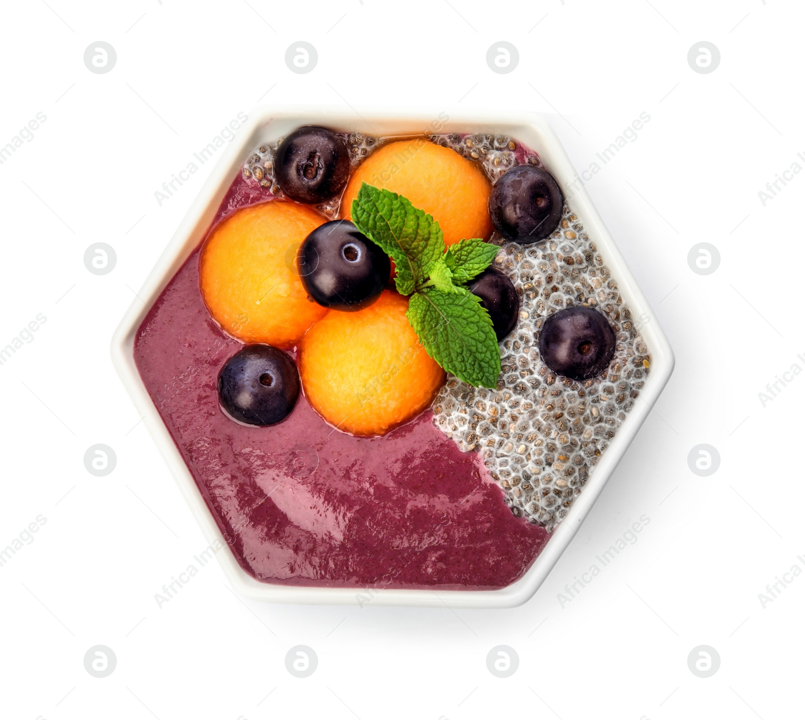 Photo of Bowl with tasty acai smoothie on white background, top view