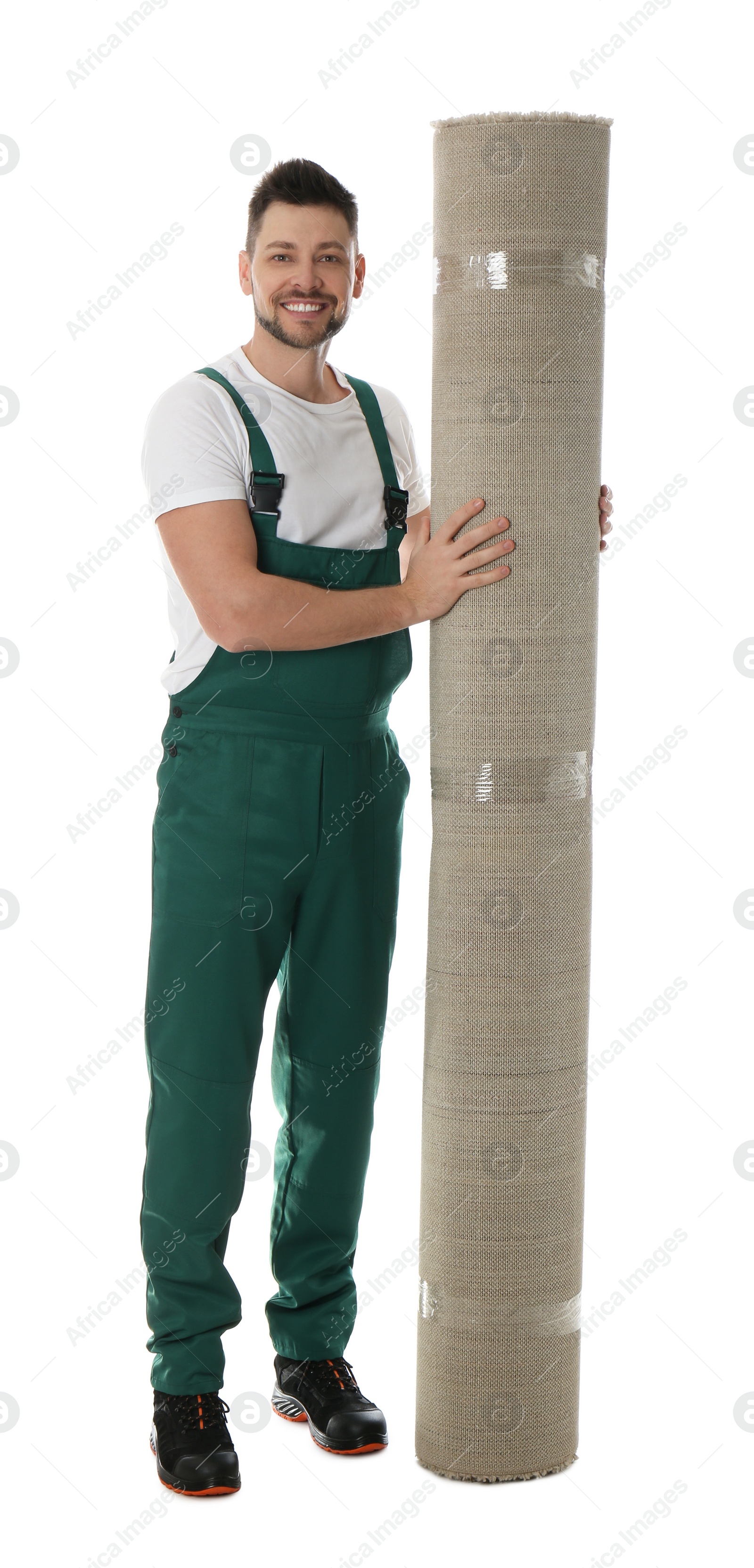 Photo of Male worker with rolled carpet on white background