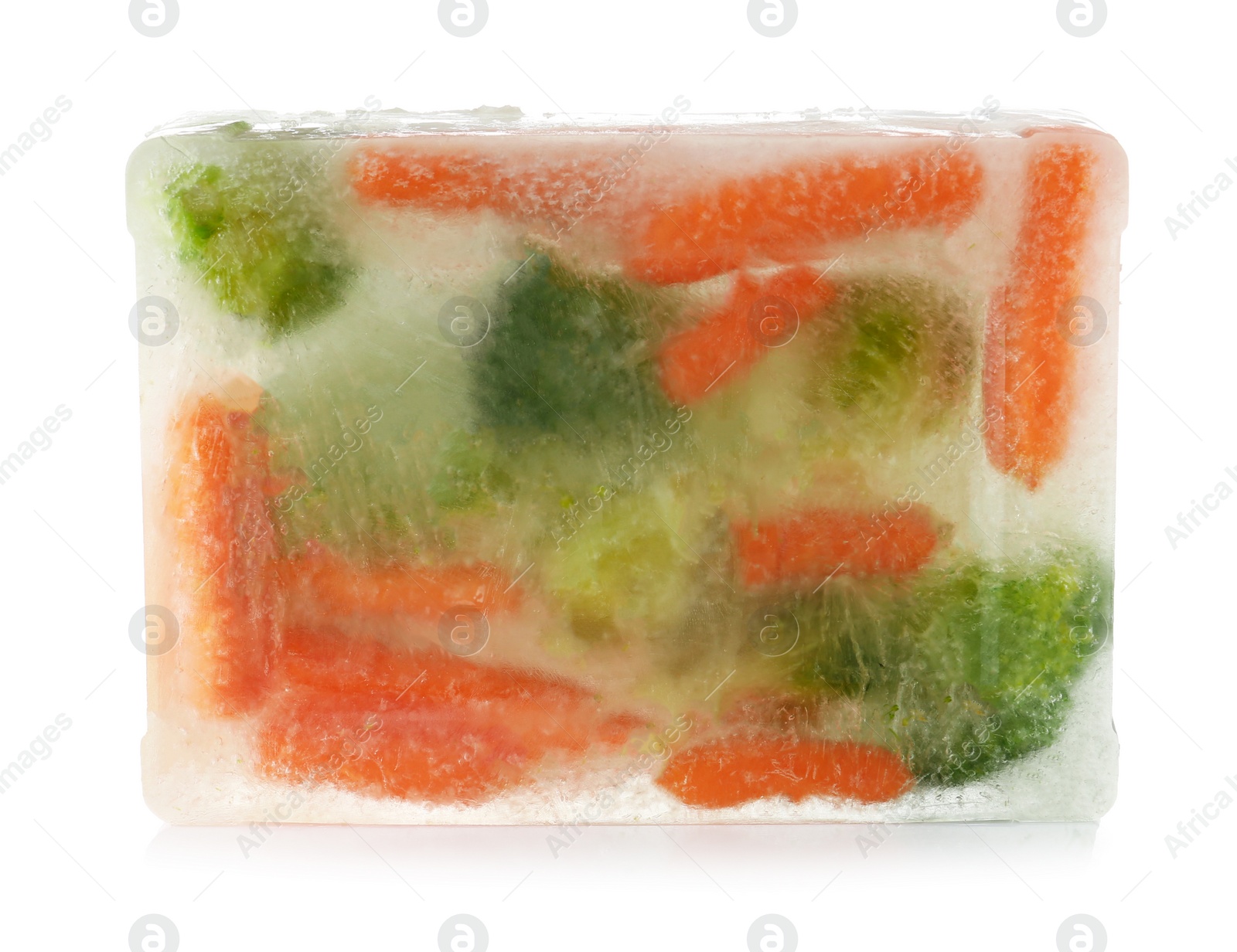 Photo of Fresh vegetables frozen in ice cube on white background