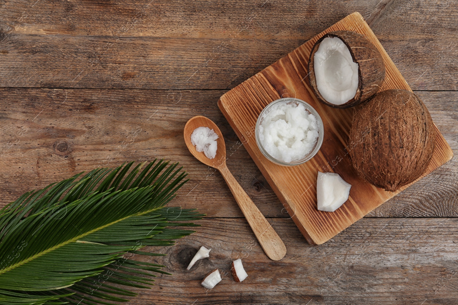 Photo of Flat lay composition with coconut oil on wooden table. Cooking ingredients