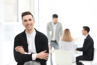 Portrait of handsome young businessman in office