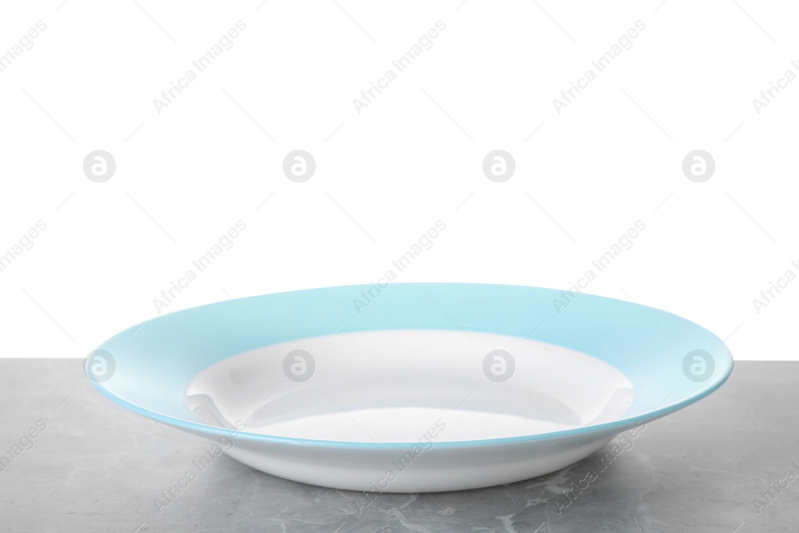 Photo of Clean empty plate on light grey marble table against white background