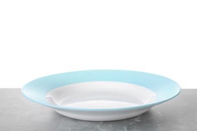 Clean empty plate on light grey marble table against white background