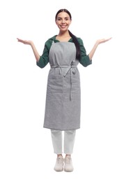 Photo of Young woman in grey apron on white background