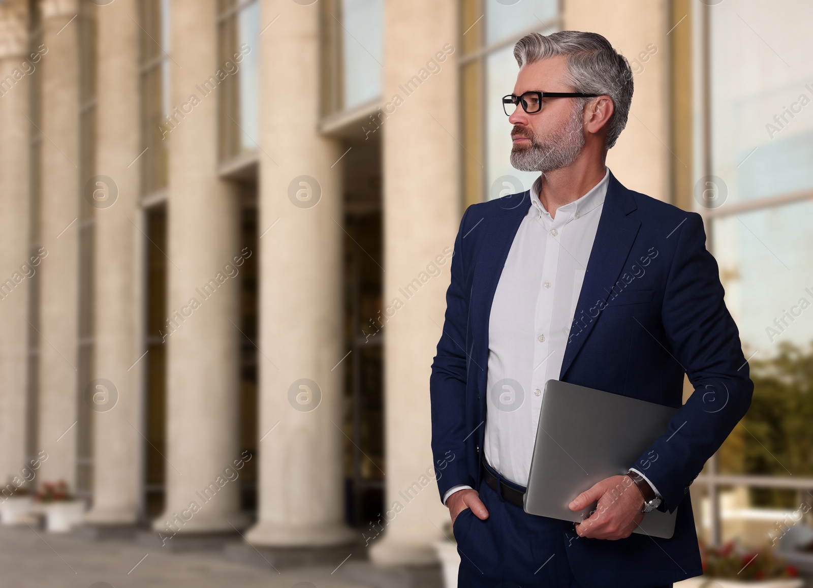 Image of Successful lawyer with laptop near building outdoors, space for text