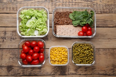 Photo of Plastic and glass containers with different fresh products on wooden table, flat lay