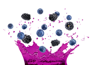 Delicious ripe berries falling in juice with splashes on white background