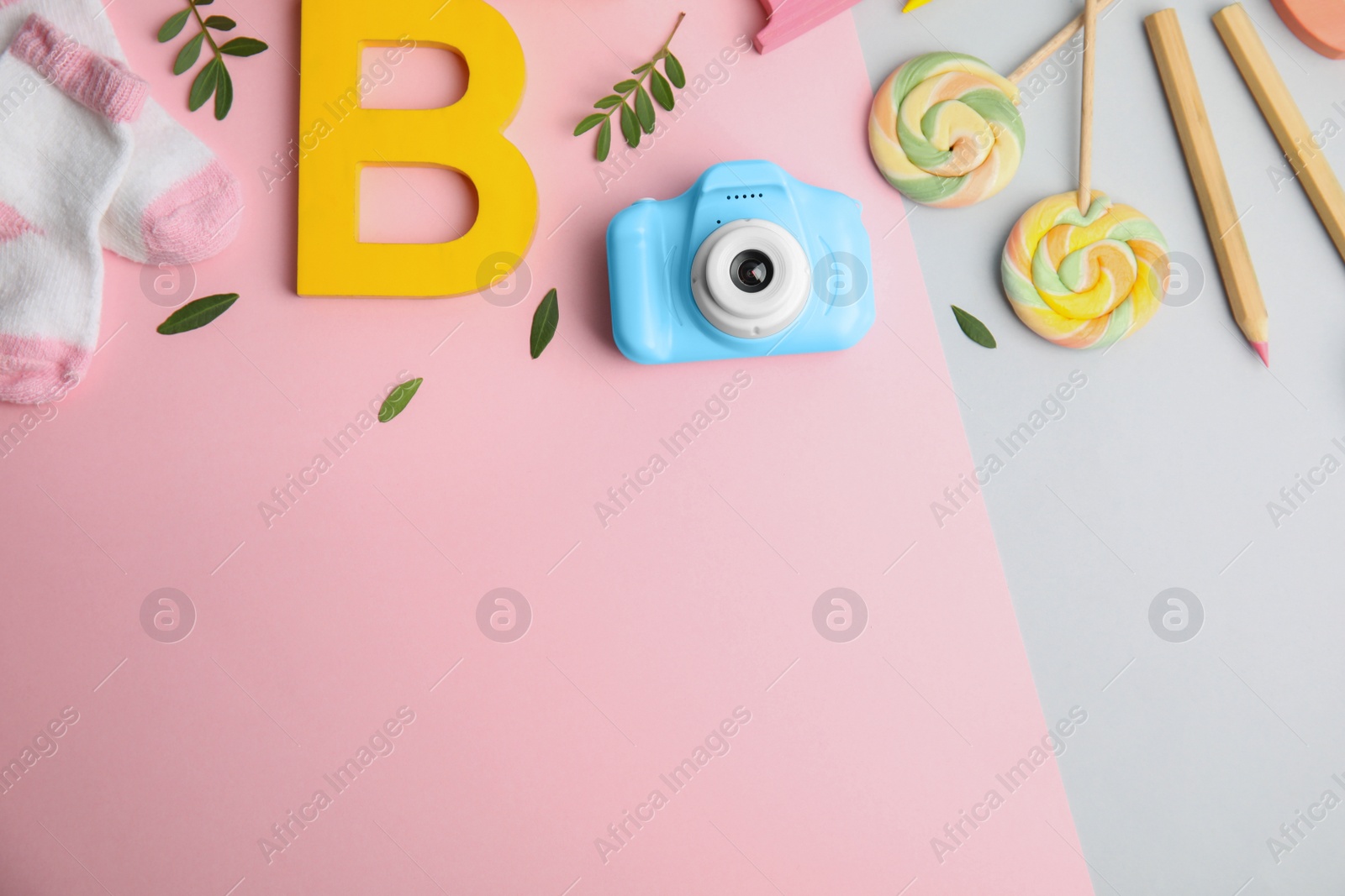 Photo of Flat lay composition with toy camera on color background, space for text. Future photographer