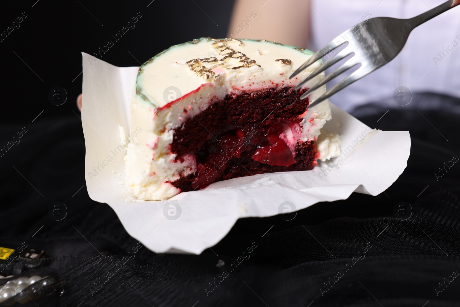 Photo of Woman eating her Birthday cake with fork, closeup