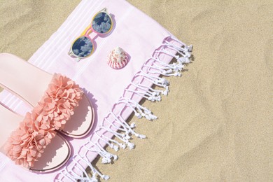 Photo of Stylish beach accessories on sand outdoors, top view. Space for text