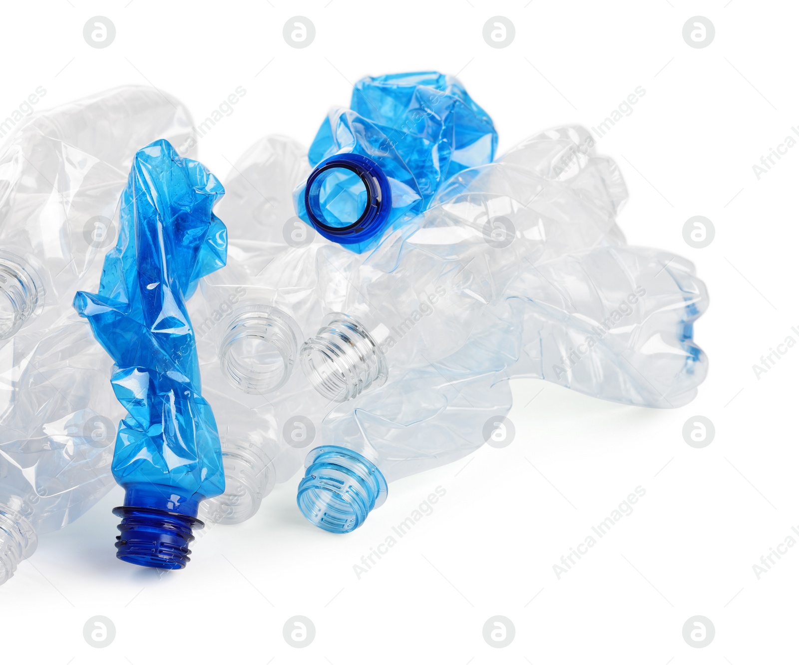 Photo of Crumpled disposable plastic bottles on white background