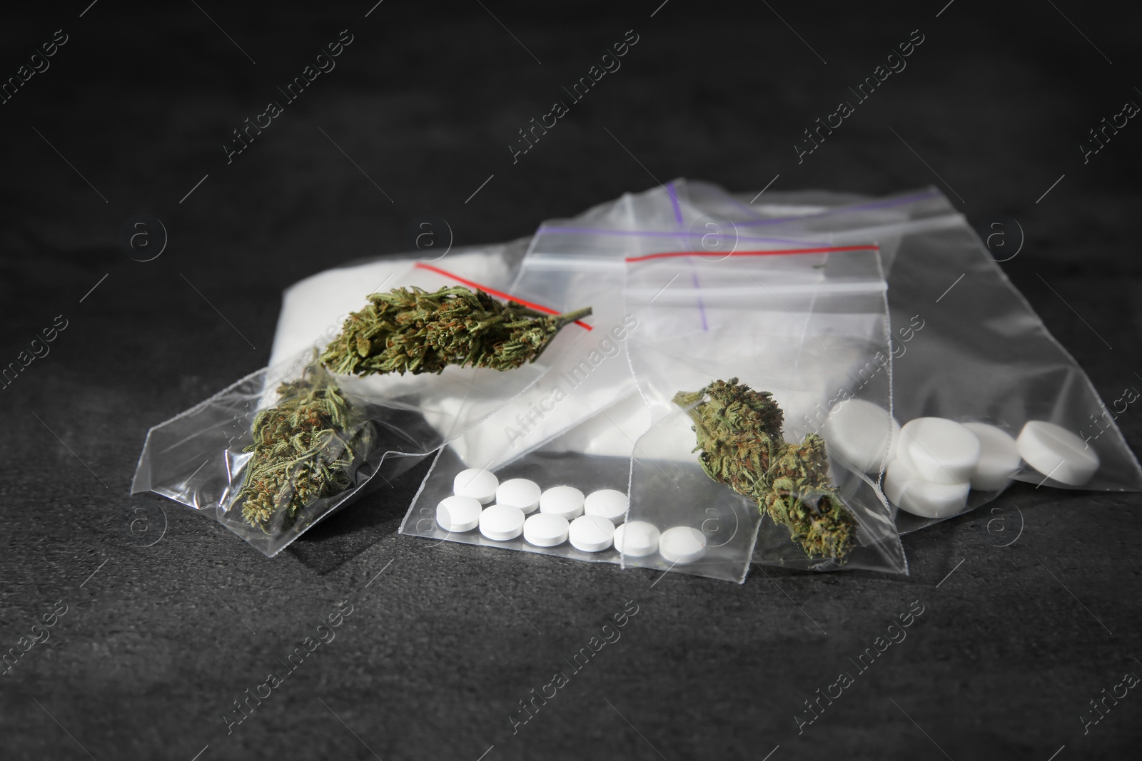 Photo of Cocaine, dried hemp and ecstasy on grey table