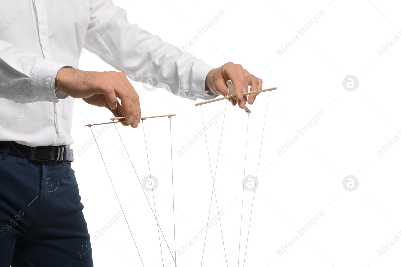 Photo of Man pulling strings of puppet on white background, closeup