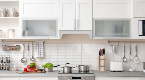 Photo of Modern kitchen interior with houseware and new furniture