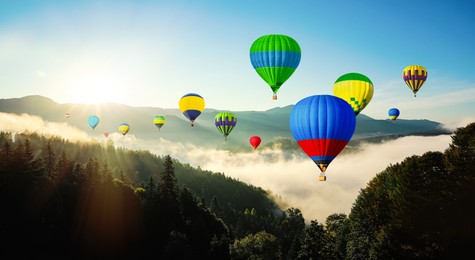 Image of Hot air balloons flying over mountains. Banner design