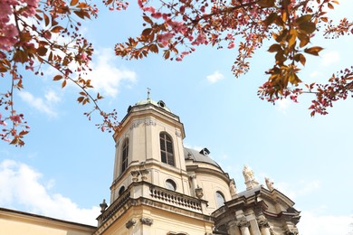 Photo of Exterior of beautiful cathedral against blue sky, low angle view