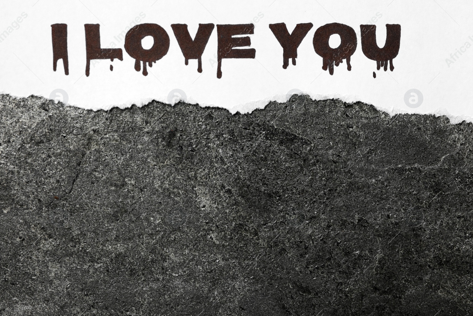 Photo of Torn sheet of paper with words I Love You on grey stone background, top view. Space for text