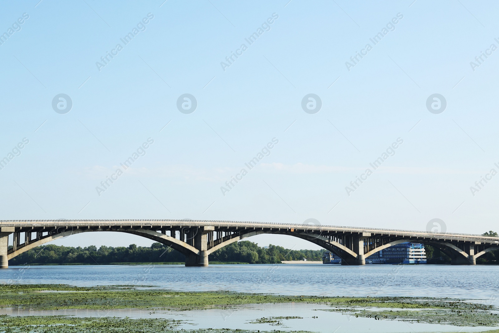 Photo of Beautiful view of arch bridge over river on sunny day