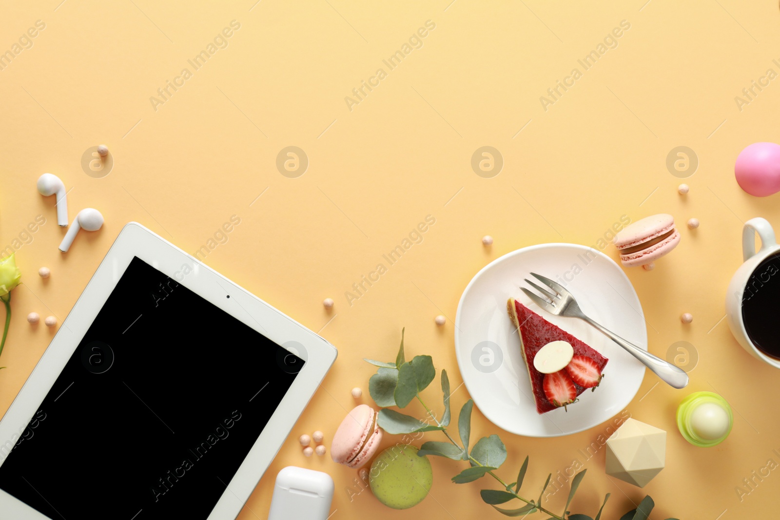 Photo of Flat lay composition with tablet on beige background. Food blogger's workplace