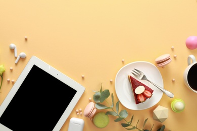 Flat lay composition with tablet on beige background. Food blogger's workplace