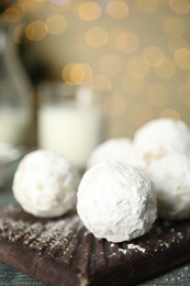 Photo of Tasty Christmas snowball cookies on table, closeup. Space for text