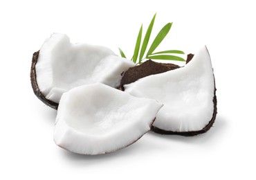 Photo of Pieces of tasty ripe coconut with green leaf on white background