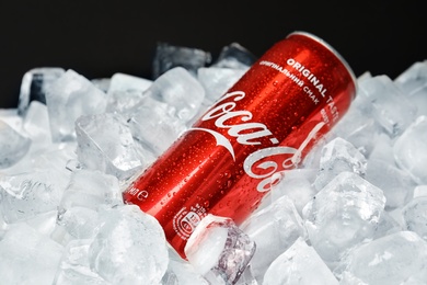 Photo of MYKOLAIV, UKRAINE - NOVEMBER 15, 2018: Coca Cola can on ice cubes against black background