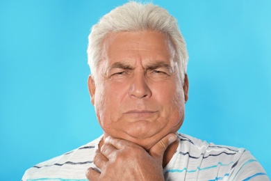 Photo of Mature man with double chin on blue background