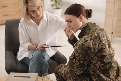 Photo of Psychotherapist working with military woman in office