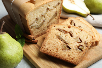 Tasty pear bread on wooden board, closeup. Homemade cake