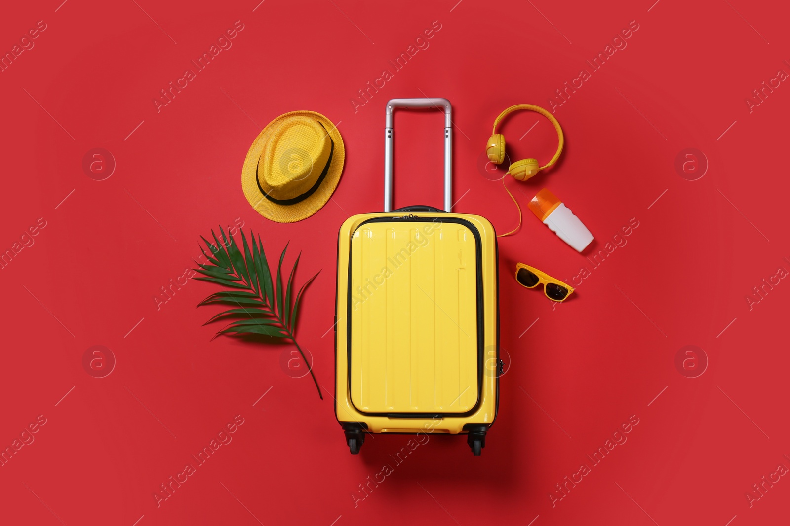 Photo of Flat lay composition with stylish suitcase and accessories on color background