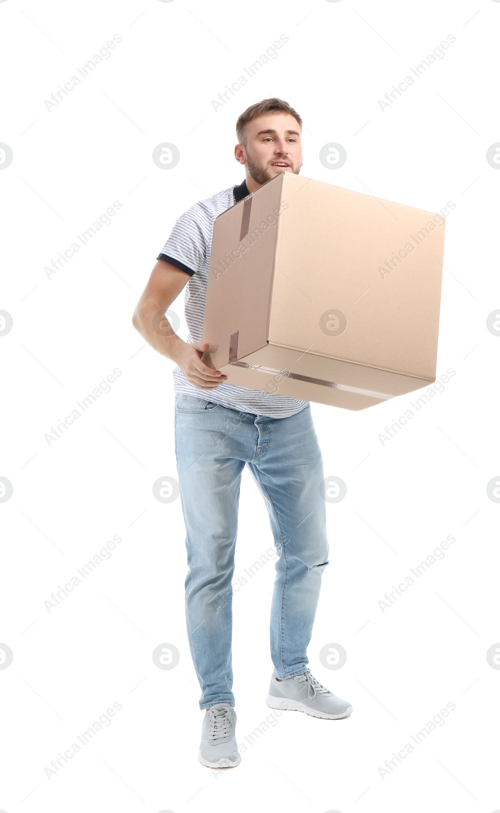 Photo of Full length portrait of young man carrying carton box on white background. Posture concept